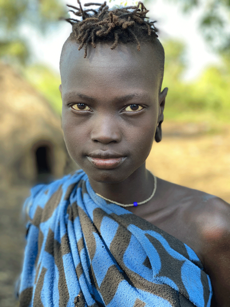 Young girl from the Omo Valley in traditional attire, representing Ethiopia’s dive